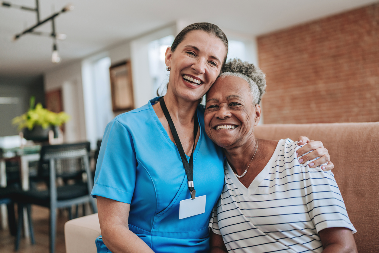 Caregiver and client smiling together