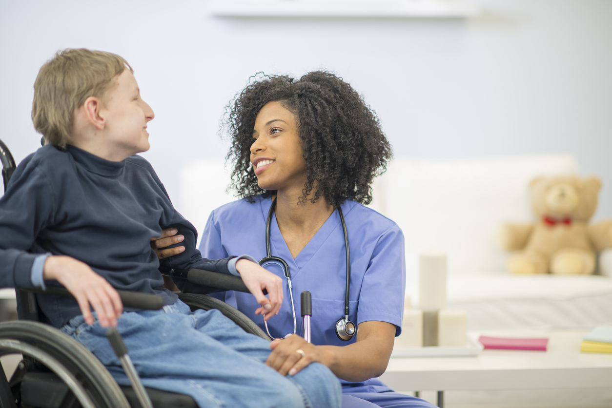 Caregiver with child in wheelchair